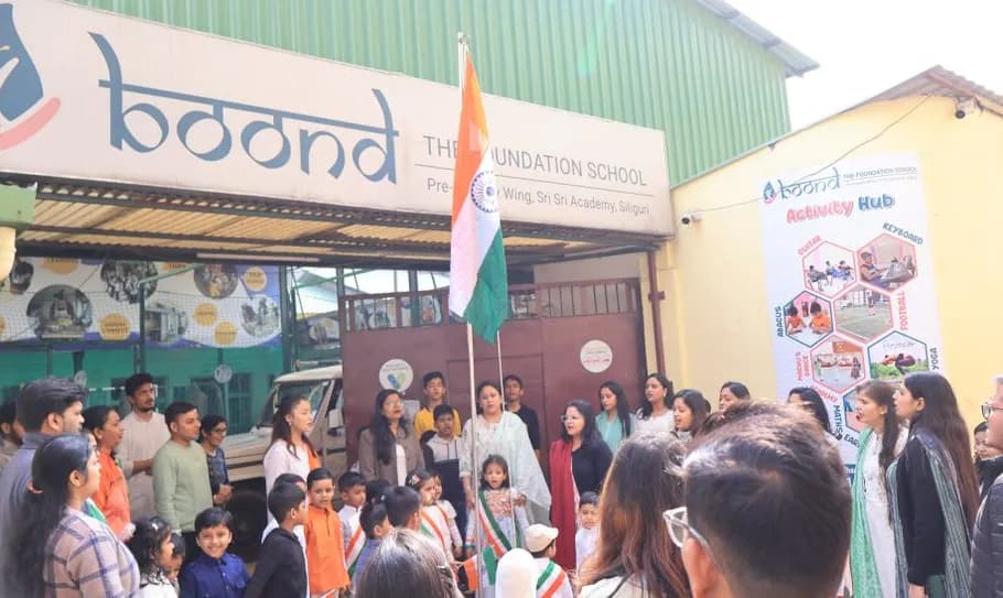 Parents and children gathered together for a flag hoisting at the junior campus