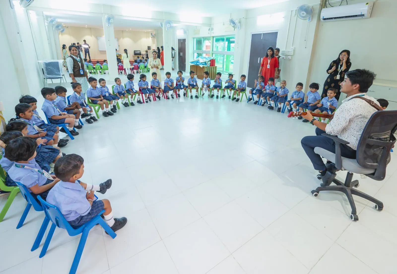 A whole class seated in a circle for a live music session