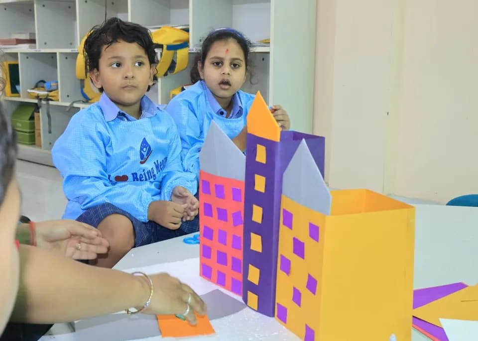 Two children building a paper city